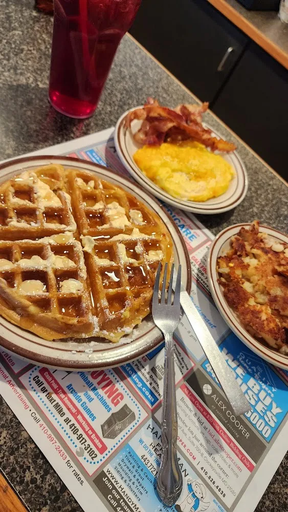 Waffles with Eggs Bacon and Home Fries